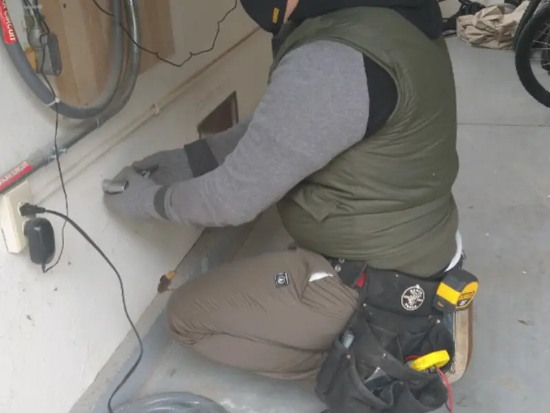 Electrician performing outlet wiring in a Richland garage